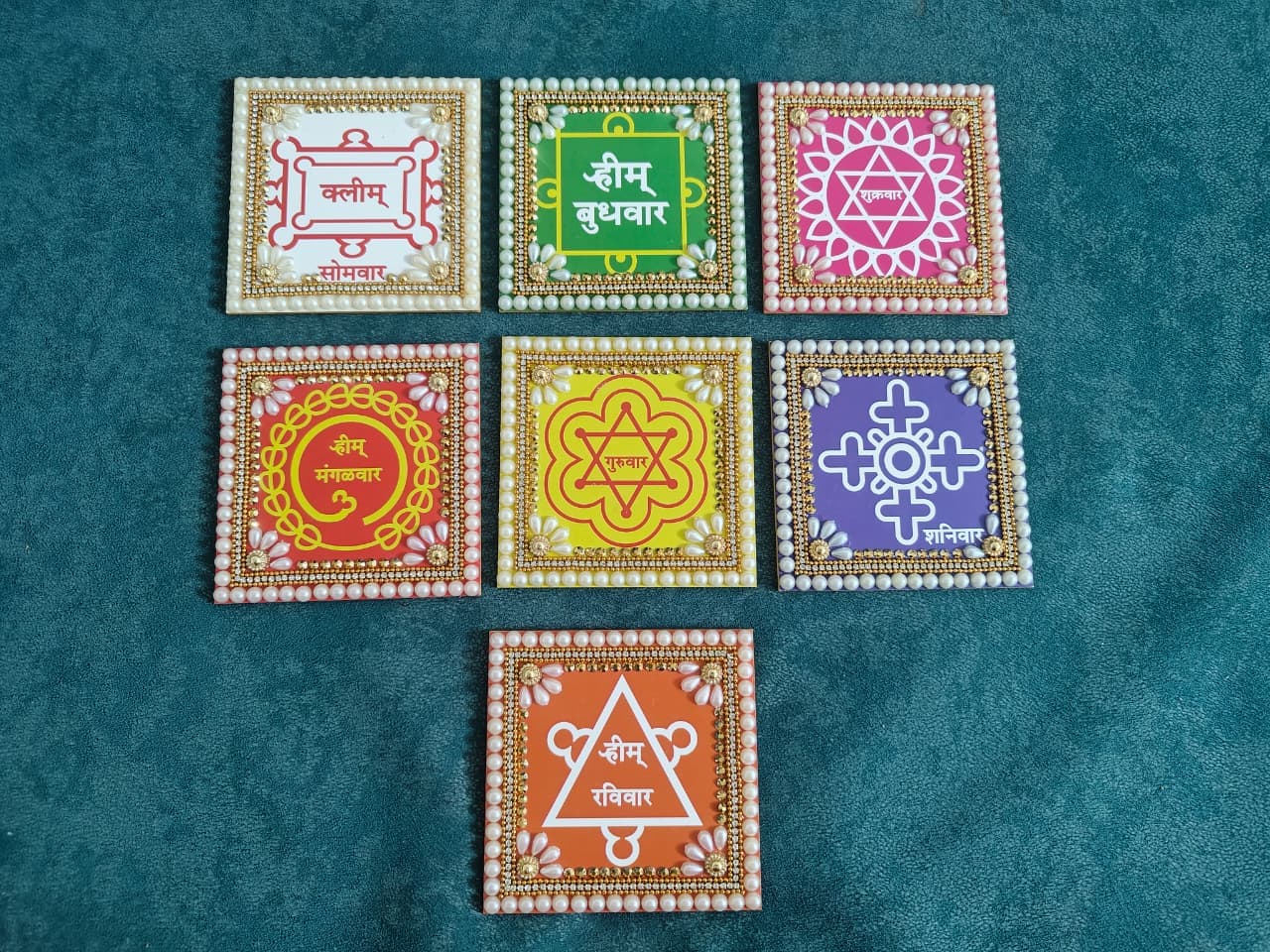 Seven-day devotional yantra set decorated with pearl and kundan work for weekly pooja