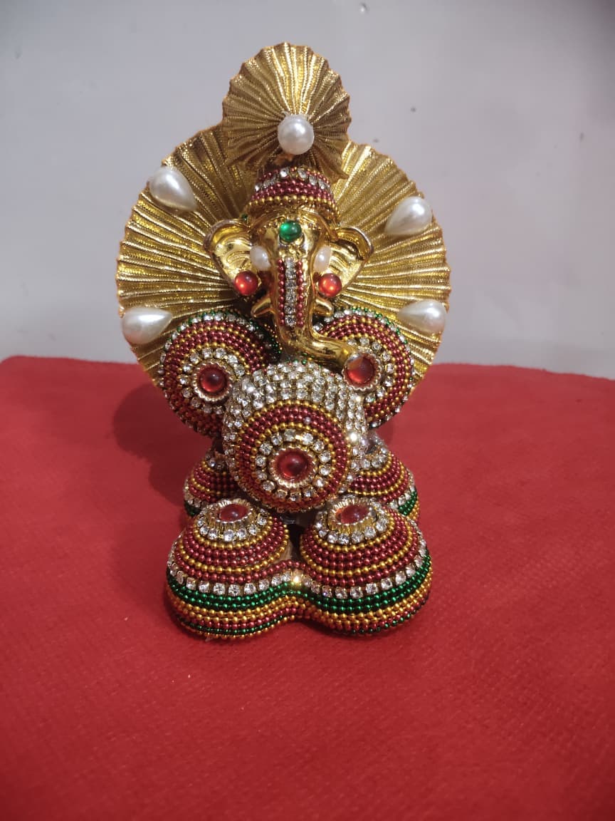 Golden Ganesha idol hand-decorated with beadwork, kundan stones and pearl embellishments