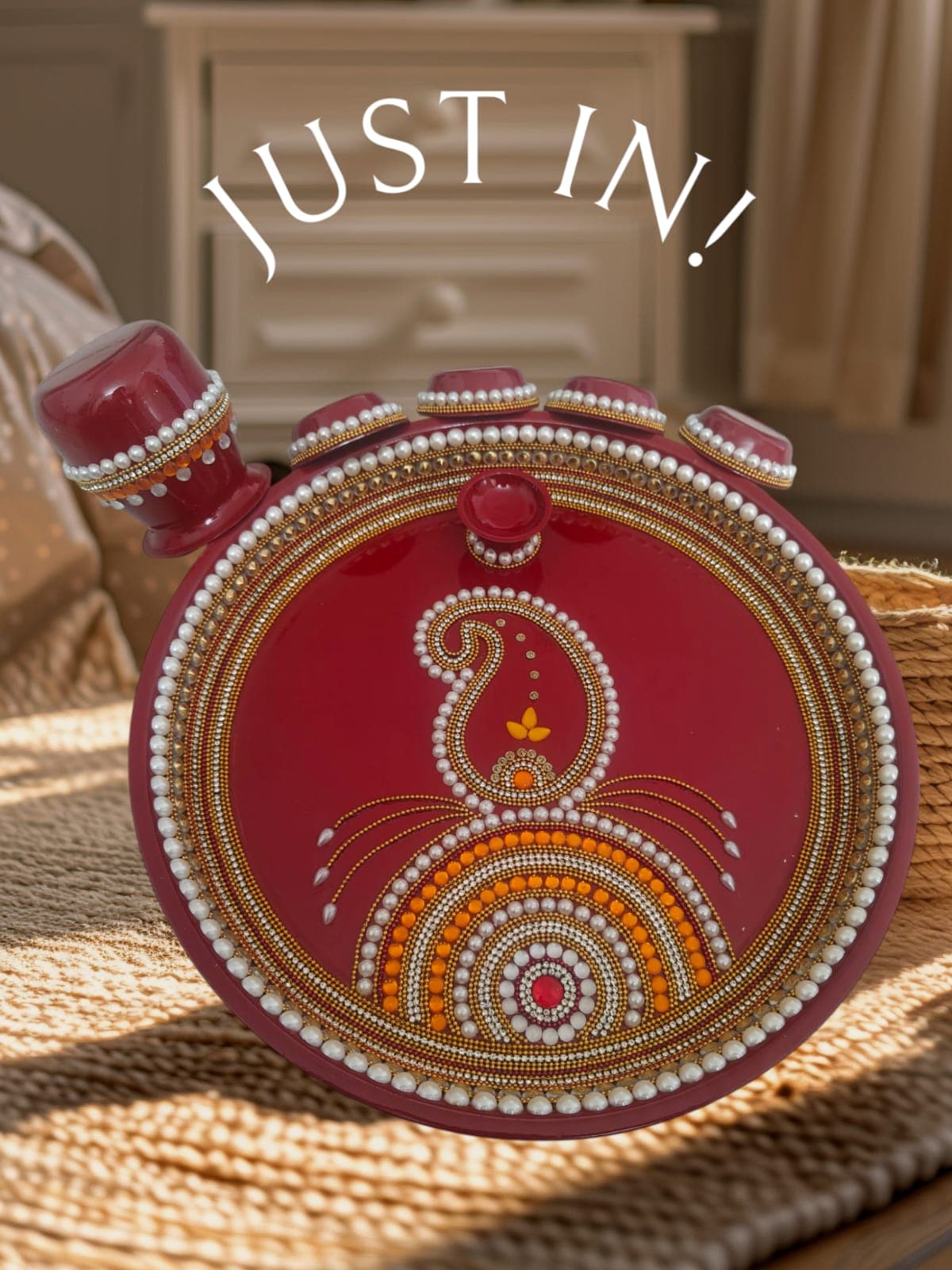 Deep red handcrafted pooja thali with peacock paisley pattern and pearl border