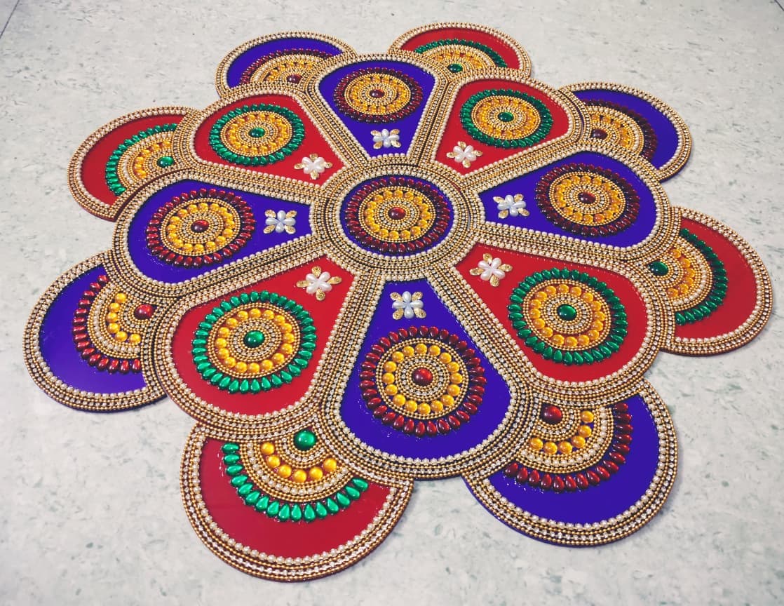 Multi-piece kundan rangoli floor set in red, blue and gold with detailed stone work